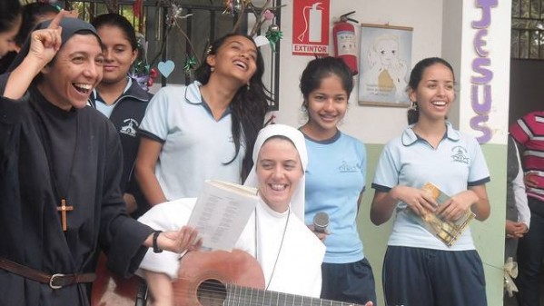 Sister Clare is fondly remembered in this picture smiling and playing her guitar,