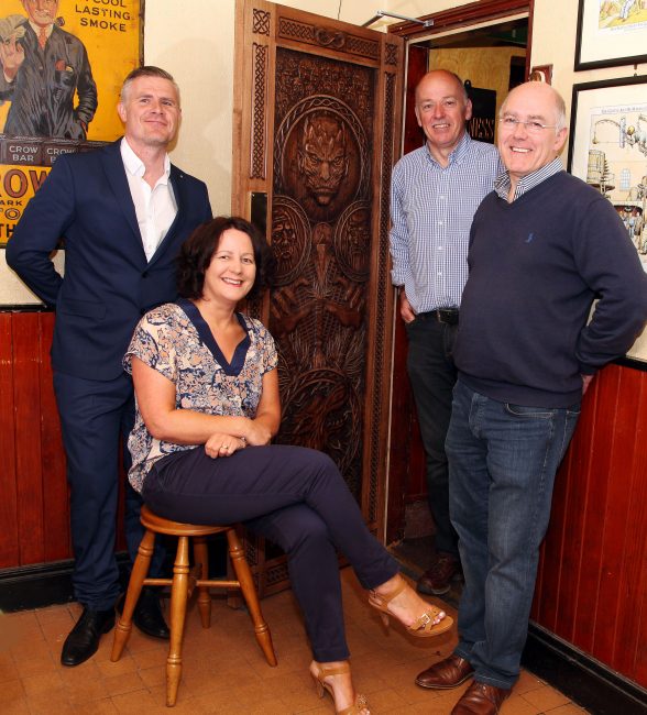 Tourism Ireland unveiled its fifth ‘Door of Thrones’ – this time in Frank’s (Owens) Bar in Limavady. PIC SHOWS: Ciaran Doherty, Tourism Ireland; Orla Farren, Tourism NI; Damian and Garry Owens, Frank’s (Owens) Bar, beside the intricately carved door which depicts scenes from episode five of series six – a feature of Tourism Ireland’s 2016 Game of Thrones® campaign – which is hanging in Frank’s (Owens) Bar in Limavady. Pic – Paul Nash 