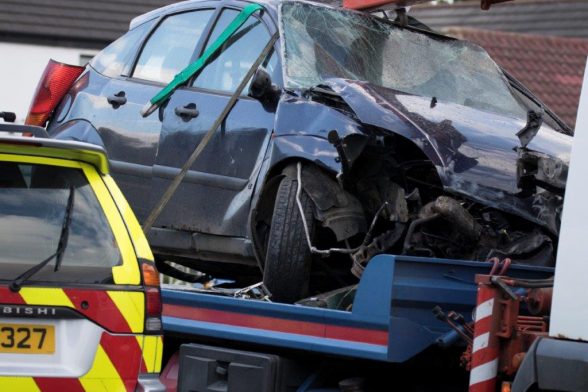 The remains of the Ford Focus car are taken away from the crash scene today